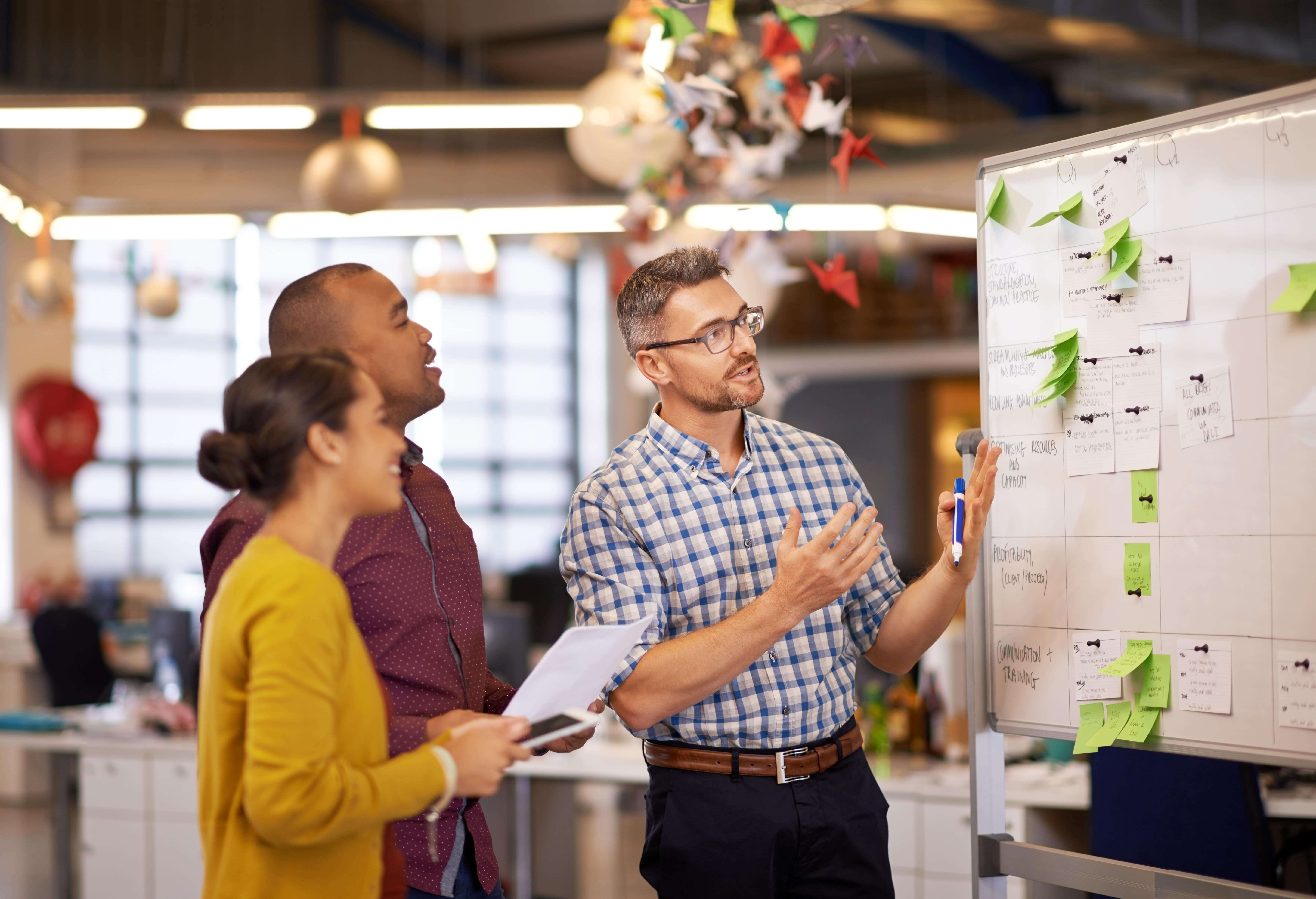 manager plan and business people with strategy and speaking in a office